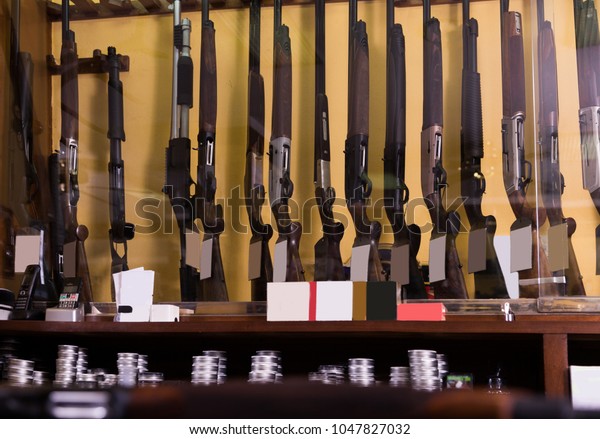 Gun shop interior\
with rifles on showcase
