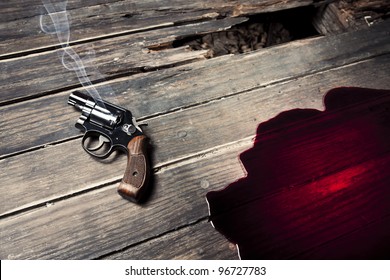 gun with smoke and blood on the floor, suicide concept