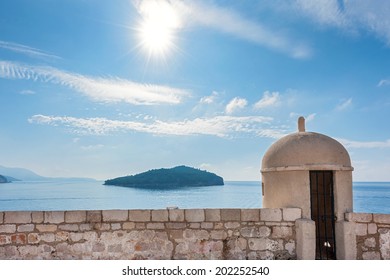 Gun turret on old city walls of Dubrovnik city (Croatia) with island Lokrum in background.