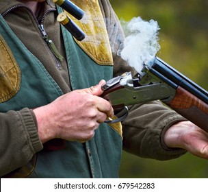 gunman with smoking shotgun after a shot
