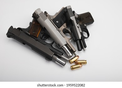 Guns , Difference size of Semi automatic pistol handguns with .45 bullets  on white background , The same of single action operating system , 1911 guns 