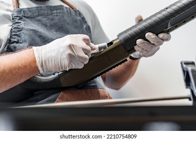 The Gunsmith Maintaining His Rifle In A Workshop