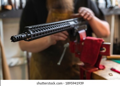 Gunsmith Working On An 300 Blackout AR Rifle Upper Receiver In A Vise At A Gun Shop In California