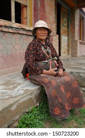 GUOLUO, CHINA - JULY 27: Unidentified old woman sit in a Tibetan Buddhism Temple on the Tibetan plateau, Tibetan people spend a lot of time on Buddhism, July 27, 2013, Guoluo, Qinghai, China