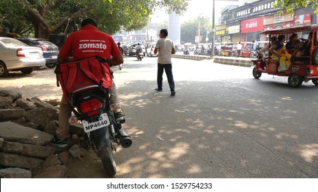 Gurgaon, Delhi, India, 2020. Delivery Boy Of Zomato, One Of The Leading Online Food Delivery App Startup In The Food Tech Space, Riding A Bike To Deliver Food. 