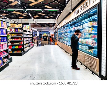 Gurgaon, Delhi, India - Circa 2020 : Young Indian Man Looking Through The Food And Drink Section Of A Modern Retail Store With Wide Aisles And Many Options. Retail Stores Like Le Marche Spencers