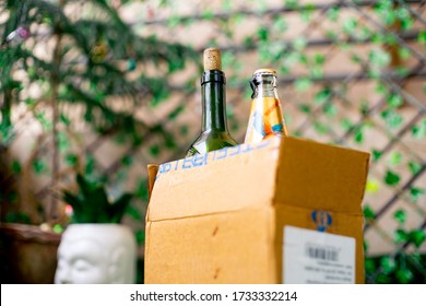 Gurgaon, Delhi, India - Circa 2020 : Alcohol In A Cardboard Box With Beer And Wine Home Delivered Through Online App Shot In A Garden At Home. Concept On Government Guideline On Home Delivery Of