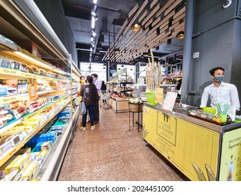 Gurgaon, Delhi, India - Circa 2021: Young Indian Woman Men And Other People Shopping For Food In The Crowded Aisle Of A Supermarket Hypermarket While Wearing Masks During The COVID Coronavirus Pandemi