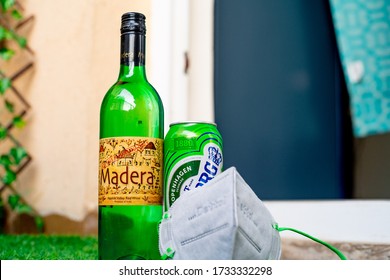 Gurgaon, Haryana, India - Circa 2020 : Alcohol Liquor Wine Beer Placed On Grass At The Entrance Of House With Mask And Sanitizer Showing Home Delivery Of Alcohol During Coronavirus Pandemic. Shows The