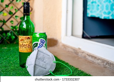 Gurgaon, Haryana, India - Circa 2020 : Alcohol Liquor Wine Beer Placed On Grass At The Entrance Of House With Mask And Sanitizer Showing Home Delivery Of Alcohol During Coronavirus Pandemic. Shows The