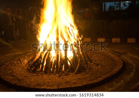 Gurgaon, India, Circa 2020 - Photograph of a giant bonfire lit for the auspicious festival of lohri or Holi or Holika Dahan. This is a spring harvest festival celebrated in India by roasting grain