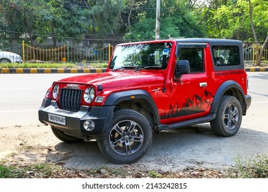 Gurgaon, India - March 4, 2022: Red Offroad Car Mahindra Thar In A City Street.