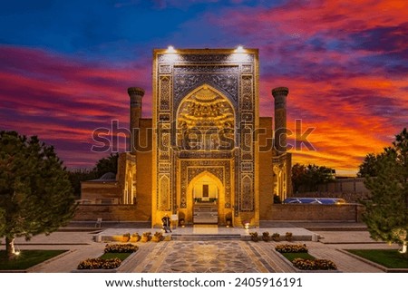 Guri Amir or Gur Emir is a mausoleum of the Mongol conqueror Amir Temur or Tamerlane in Samarkand, Uzbekistan at sunset

Translation: In the name of Allah Almighty who creates