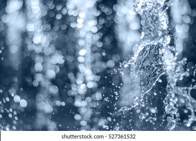 The gush of water of a fountain. Splash of water in the fountain, abstract image. Defocused - Shutterstock ID 527361532