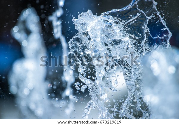 The gush
of water of a fountain. Splash of water in the fountain, abstract
image.Foam in the sea. The gush of water of a fountain. Splash of
water in the fountain, abstract
image.