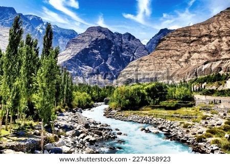 Gushing turquoise water of Gizer River, passing through a contrasting mountains in Gilgit-Baltistan, Pakistan  