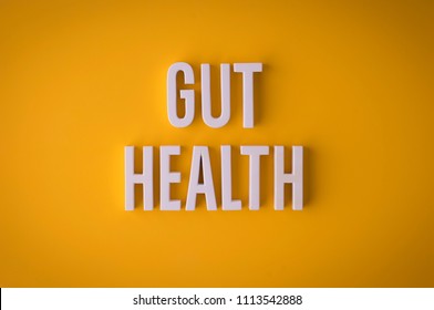 Gut Health Lettering Sign Made With Colorful Background And White Ceramic Letters.