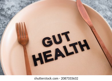 Gut Health Text On Dining Plate With Fork And Knife, Healthy Nutrition And Scientific Research About The Microbiome	