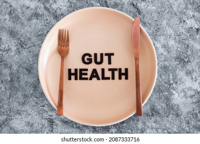 Gut Health Text On Dining Plate With Fork And Knife, Healthy Nutrition And Scientific Research About The Microbiome	