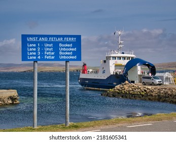 Gutcher, UK - May 8 2022: Signage and the interisland roll on - roll off ferry MV Bigga at the ferry terminal at Gutcher on the island of Yell in Shetland, UK. Taken on a sunny day with a blue sky.