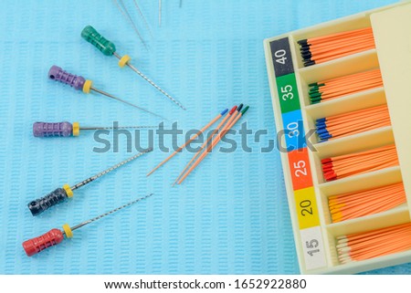 gutta-percha pins in a set of different sizes for root canal filling, endodontic needle and equipment close-up, material for endodontic filling, selective focus