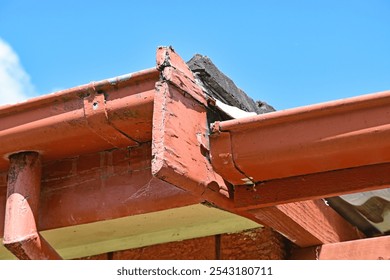 Gutter eves and facia with downpipe on an old house