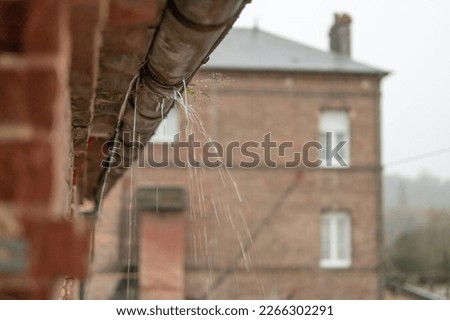 a gutter on a building, an old drainpipe close-up, water flows through rotten metal, there is a place for an inscription