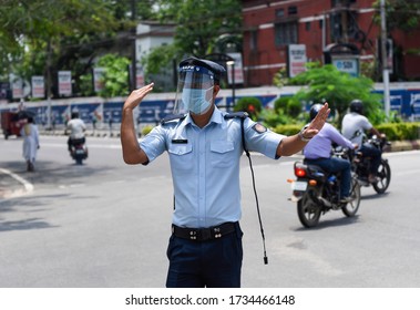 Guwahati, Assam, India. 18 May 2020. Traffic police personnel on duty wearing face shield, during the ongoing COVID-19 lockdown, in Guwahati.