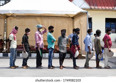 Guwahati, Assam, India. 4 June 2020. Migrants Wait In Queues To Receive Food Being Distributed By The Volunteers Outside The Guwahati Railway Station During Ongoing COVID-19 Lockdown, In Guwahti.