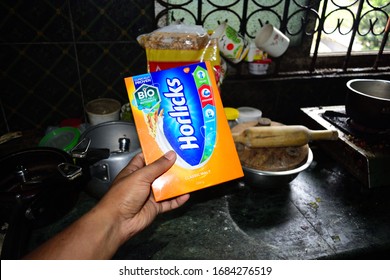 Guwahati,Assam,India - March 26 2020: A Men Holding A Horlicks Health Drink Packet. Horlicks Is Nutritional Food Powder Helps In Balancing Your Child & Nutrition