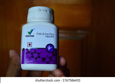 Guwahati,Assam,India - May 03 2020: A Person Holding A Bottle Of Vestige Brand  Iron Capsules. These Are Used As A Supplements