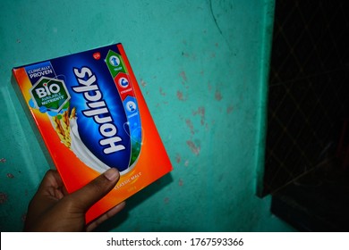 Guwahati,Assam,India - May 21 2020: A Men Holding A Horlicks Health Drink Packet. Horlicks Is Nutritional Food Powder Helps In Balancing Your Child & Nutrition