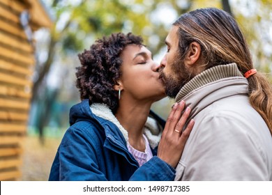 guy with an african girl in love in autumn park walk at sunset