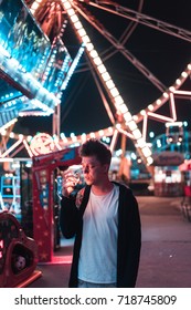 Guy in an amusement park posing at the camera