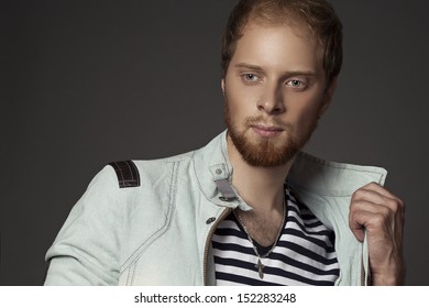 a guy with a beard in a denim jacket