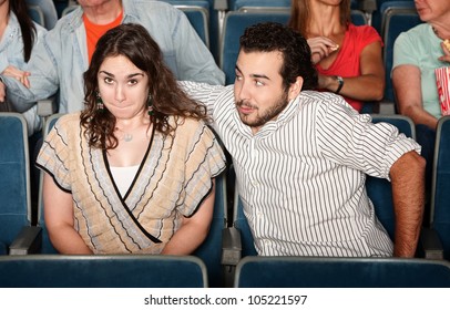 Guy In Beard Flirts With Young Woman In Theater