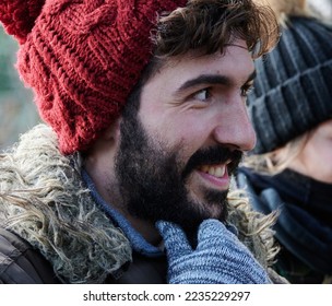 A guy with a beard and a red hat
