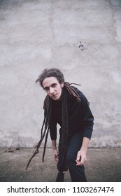  guy in black clothes  with dreadlocks on his head