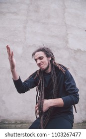  guy in black clothes  with dreadlocks on his head
