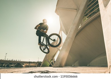 Guy with a bmx doing tricks for the city. Concept of young people doing extreme sports - Powered by Shutterstock