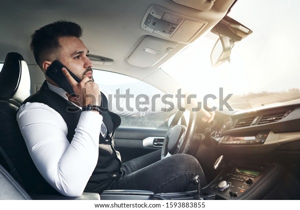 guy in car with laptop and\
phone