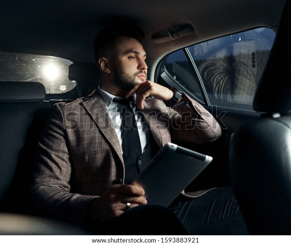 guy in car with laptop and\
phone