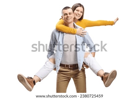 Guy carrying a happy young woman on his back isolated on white background