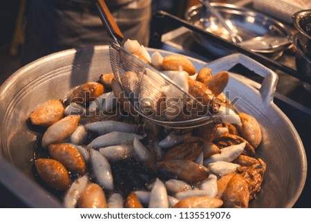guy cooking make fry of meat ball from fish meat, also call fish ball