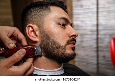 The Guy Is A Dark-haired Asian Indian Appearance On A Haircut In A Barbershop . Cinematic Image