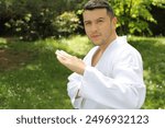 Guy doing a martial arts pose in the park 