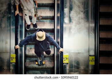 Guy doing skateboard in the escalor