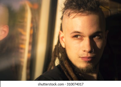 Guy with dreadlocks sitting and thinking on the train. - Powered by Shutterstock