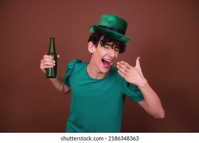 A Guy Dressed As A Drag Queen Drinks Beer. St.Patrick 's Day.