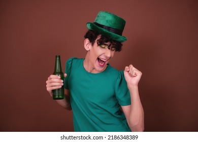 A Guy Dressed As A Drag Queen Drinks Beer. St.Patrick 's Day.